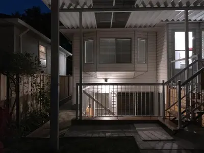 a front porch of a house at night at Perfect Location - Entire Suite Private Entrance with private bathroom & living room - 5 Mins Walk to Skytrain & Restaurant & Banks, 2 Stops To Metrotown, 5 Stops To Downtown in Vancouver