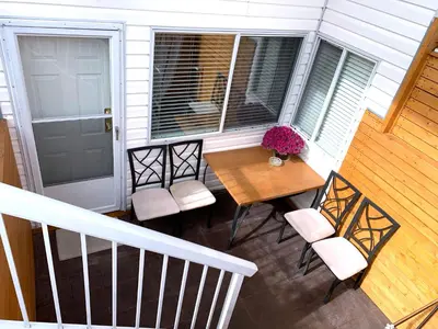 a porch with a table and chairs and a door at Perfect Location - Entire Suite Private Entrance with private bathroom & living room - 5 Mins Walk to Skytrain & Restaurant & Banks, 2 Stops To Metrotown, 5 Stops To Downtown in Vancouver