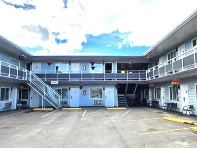 a large building with a parking lot in front of it at Ace Motel in Princeton