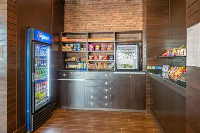 a convenience store with a refrigerator and some food at Four Points by Sheraton Edmonton International Airport in Nisku