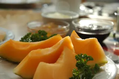 a plate of food with cheese and broccoli on a table at Cambie Lodge in Vancouver