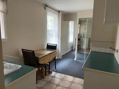 a kitchen with a desk with a laptop on it at Douglas Guest House in Vancouver