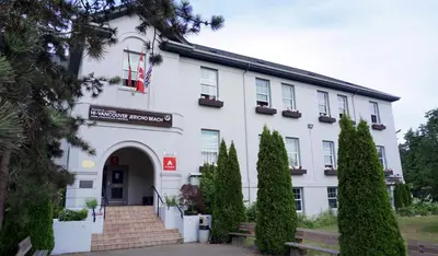 a large white building with a staircase in front of it at HI Vancouver Jericho Beach - Hostel in Vancouver