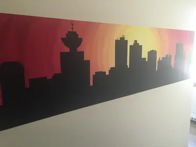 a mural of a city skyline on a wall at HI Vancouver Jericho Beach - Hostel in Vancouver