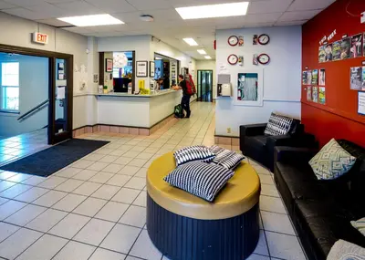 a lobby of a store with a couch and a counter at HI Vancouver Jericho Beach - Hostel in Vancouver