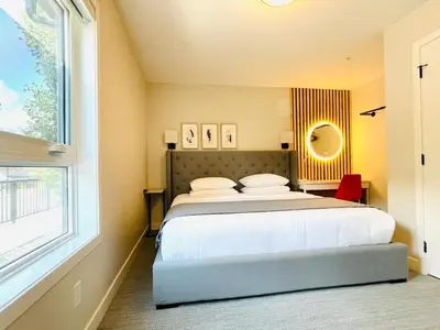 a bedroom with a large bed and a window at Joe's Contemporary 2 King Bedrooms Vacation Home in Canmore in Canmore