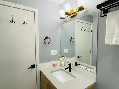 a bathroom with a sink and a mirror at Joe's Contemporary 2 King Bedrooms Vacation Home in Canmore in Canmore