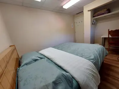 a bedroom with a large bed in a room at Green Village in Calgary