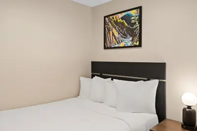 a bedroom with a bed and a picture on the wall at Worldmark Whistler Sundance in Whistler