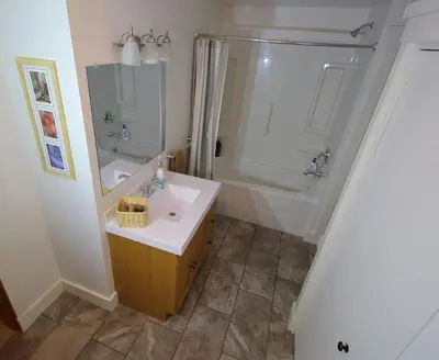 a bathroom with a sink and a shower and a tub at Mossy Hill Suite in Salt Spring Island