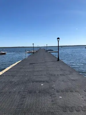 a pier in the middle of a body of water at Shoreside Inn & Suites in Wabamun