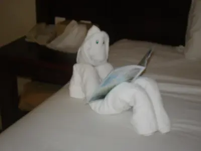 a stuffed white teddy bear sitting on top of a bed at Shoreside Inn & Suites in Wabamun