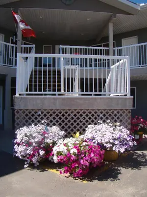 a bunch of flowers in front of a house at Shoreside Inn & Suites in Wabamun