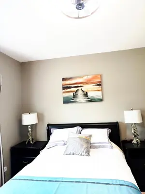 a bedroom with a bed with two lamps at V.I.P. CLUB in Surrey