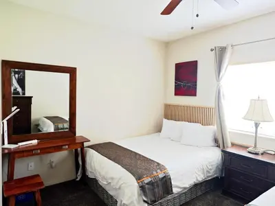 a bedroom with a bed and a mirror at V.I.P. CLUB in Surrey