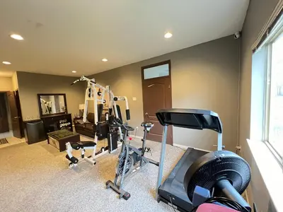 a room with a gym with a treadmill and exercise equipment at V.I.P. CLUB in Surrey