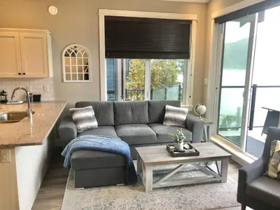 a living room with a couch and a table at Sandy Feet Retreat Port Renfrew- Oceanfront 2BR modern cottage in Port Renfrew