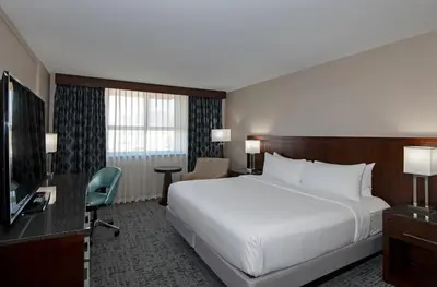 a hotel room with a large bed and a television at DoubleTree by Hilton - Kamloops in Kamloops