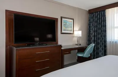 a hotel room with a flat screen tv and a desk at DoubleTree by Hilton - Kamloops in Kamloops