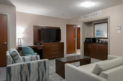a living room with a couch and a tv at DoubleTree by Hilton - Kamloops in Kamloops