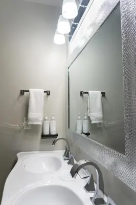 a bathroom with a white sink and a mirror at The Baker Hotel in Cranbrook