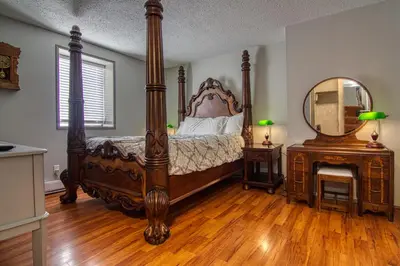 a bedroom with a canopy bed and a mirror at The Baker Hotel in Cranbrook