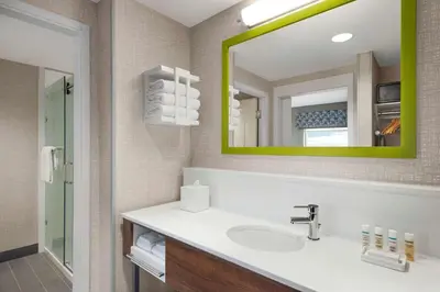 a bathroom with a sink and a mirror at Hampton Inn & Suites Kelowna, British Columbia, Canada in Kelowna