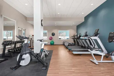 a gym with a row of treadms and cardio machines at Hampton Inn & Suites Kelowna, British Columbia, Canada in Kelowna