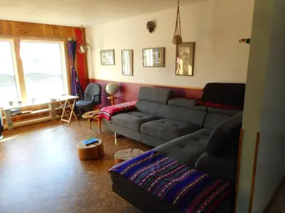 a living room with a couch and a table at Cabine, Home Sweet Home in Whitehorse