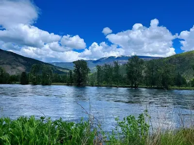 a view of a river with mountains in the background at Rivermount Motel in Little Fort