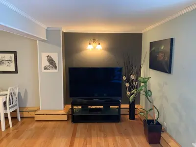 a living room with a large flat screen tv at Great Slave Lakeside Bed & Breakfast in Yellowknife