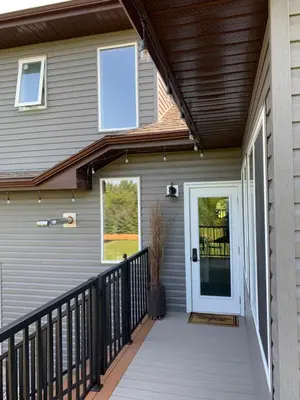 a front porch of a house with a white door at Dragonfly Inn Loft Suite in Sherwood Park