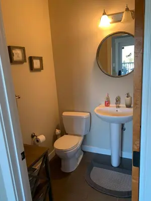 a bathroom with a toilet and a sink at Dragonfly Inn Loft Suite in Sherwood Park