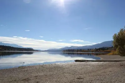a view of a lake with mountains in the background at Rustic Modern 2 Bed 2 Bath with Lakeview Pool and Hot Tub in Invermere