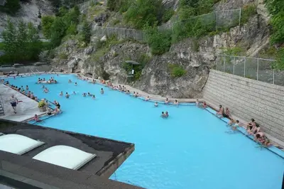 a group of people in a large swimming pool at Rustic Modern 2 Bed 2 Bath with Lakeview Pool and Hot Tub in Invermere