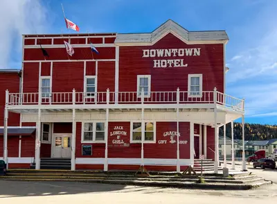 a red building with a sign that says lynatown hospital at The Downtown, a Coast Hotel in Dawson City
