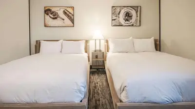 two beds sitting next to each other in a room at Midnight Sun, a Coast Hotel in Dawson City