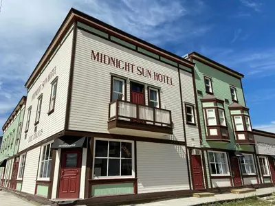 a building with a sign that reads hammer hit star hotel at Midnight Sun, a Coast Hotel in Dawson City