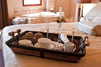 a tray with cups and dishes on a bed at High Hopes Bed and Breakfast in Hope