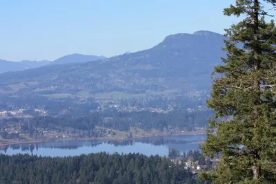 a view of a lake with mountains in the background at Eaglenest Manor Cowichan in Duncan