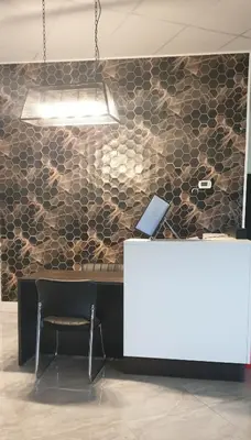 a desk with a laptop on top of a wall at New Frontier Hotel in Coronation