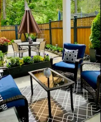 a patio with chairs and a table at A Cozy Family get away suite in South Nanaimo in Nanaimo