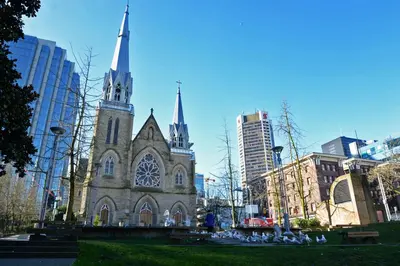 an old church with two towers in a city at Vancouver Hideaway Guesthouse in Vancouver