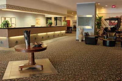 a lobby with a waiting area with a table in the middle at Westlock Inn & Conference Centre in Westlock