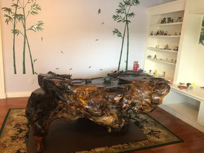 a statue of a tree stump in a living room at Hamptons Rose garden family! in Calgary