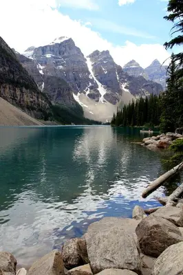 a view of a lake with mountains in the background at Mountain View Escape - Copperstone 2BR & Hot Tub in Canmore