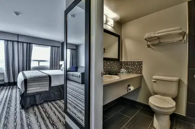 a small bathroom with a toilet and a sink at The View Hotel in Fort Saint James