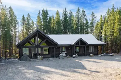 a log cabin in the middle of a forest at Timber Lodge in Valemount