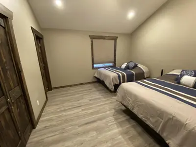 a bedroom with two beds and a window at Timber Lodge in Valemount