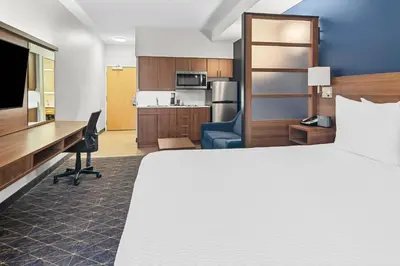 a hotel room with a bed and a desk at Park Inn by Radisson, Kelowna in Kelowna